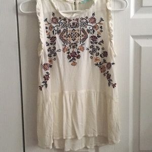 Embroidered sleeveless peplum top